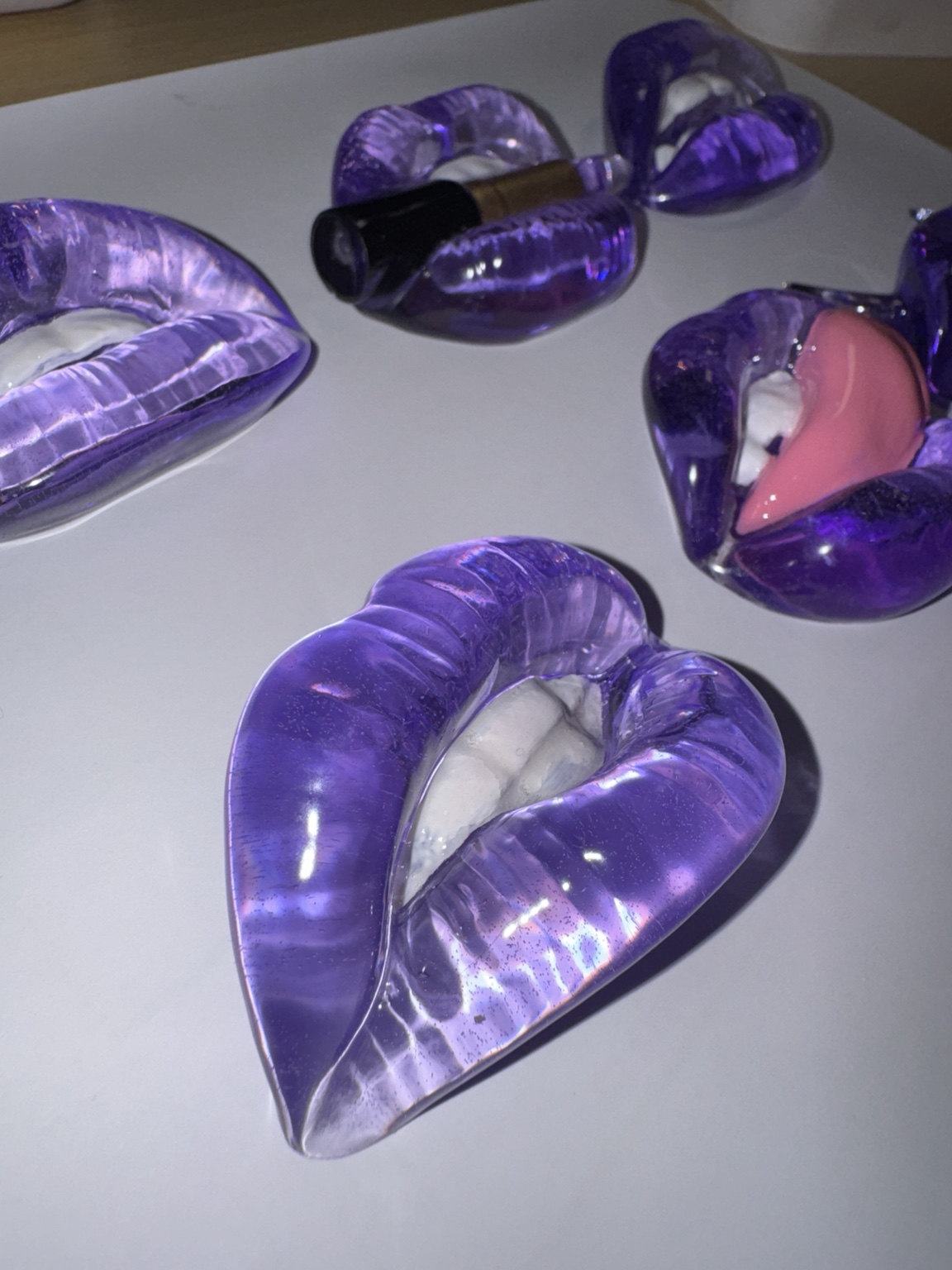 Translucent purple 3D lip artworks in several sculptural styles